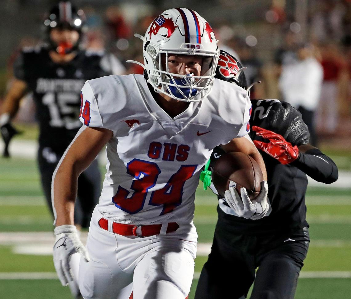 Grapevine running back Reid Watkins (34) gains yards up the middle in the second half of a high school football game at Mustang-Panther Stadium in Grapevine Texas, Friday, Sept. 30, 2022. Grapevine defeated Colleyville Heritage 44-26 for The Battle of the Red Rail. (Special to the Star-Telegram Bob Booth)