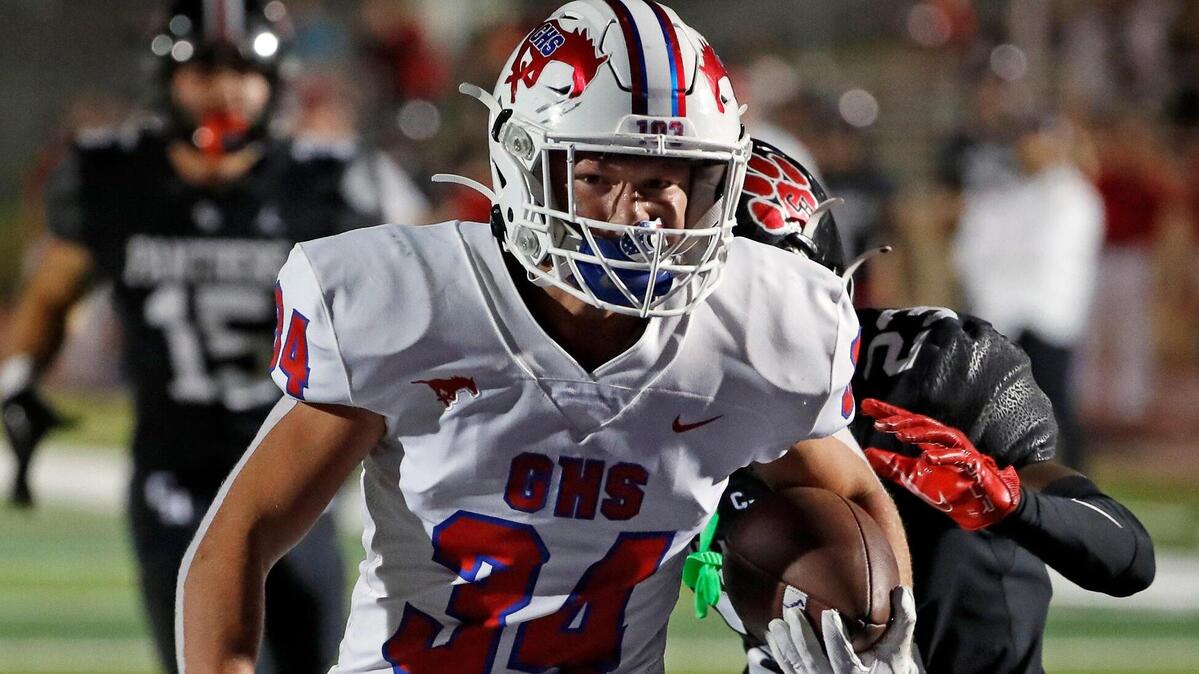 Grapevine running back Reid Watkins (34) gains yards up the middle in the second half of a high school football game at Mustang-Panther Stadium in Grapevine Texas, Friday, Sept. 30, 2022. Grapevine defeated Colleyville Heritage 44-26 for The Battle of the Red Rail. (Special to the Star-Telegram Bob Booth)