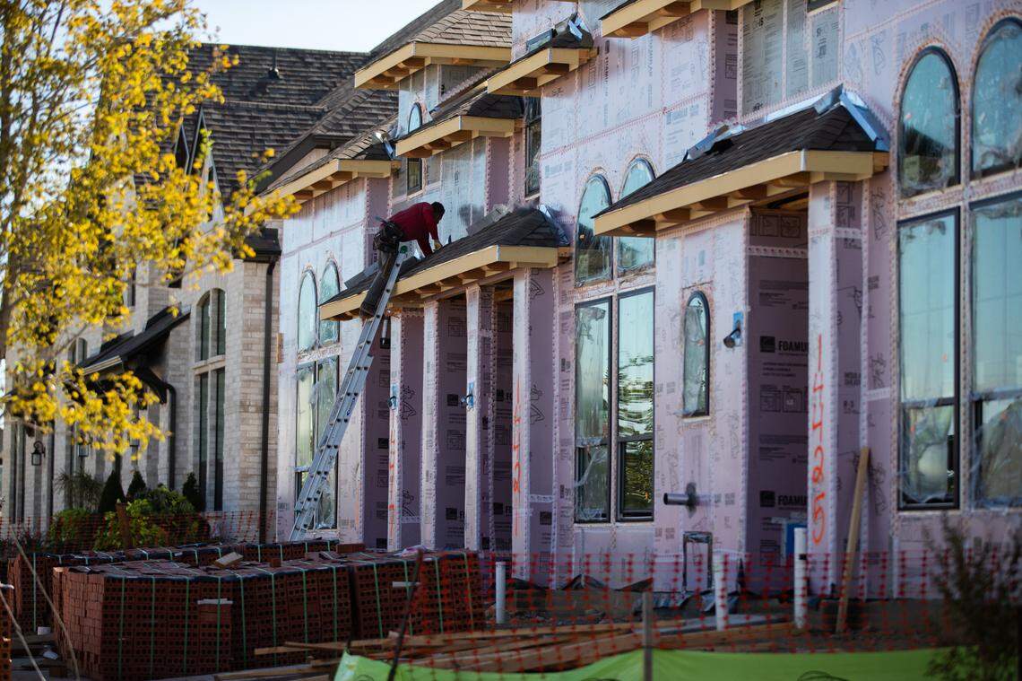A worker works on a ladder at a house construction at Walsh Ranch Wednesday, Oct. 27, 2021, in west Fort Worth.