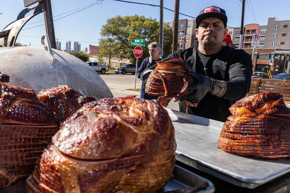Panther City BBQ co-owner Ernie Morales takes out the smoked holiday hams at Panther City BBQ in Fort Worth on Wednesday, Nov. 20, 2024. Panther City BBQ landed a spot on the Michelin recommended list making it one of the three restaurants Fort Worth to make the prestigious catalog.