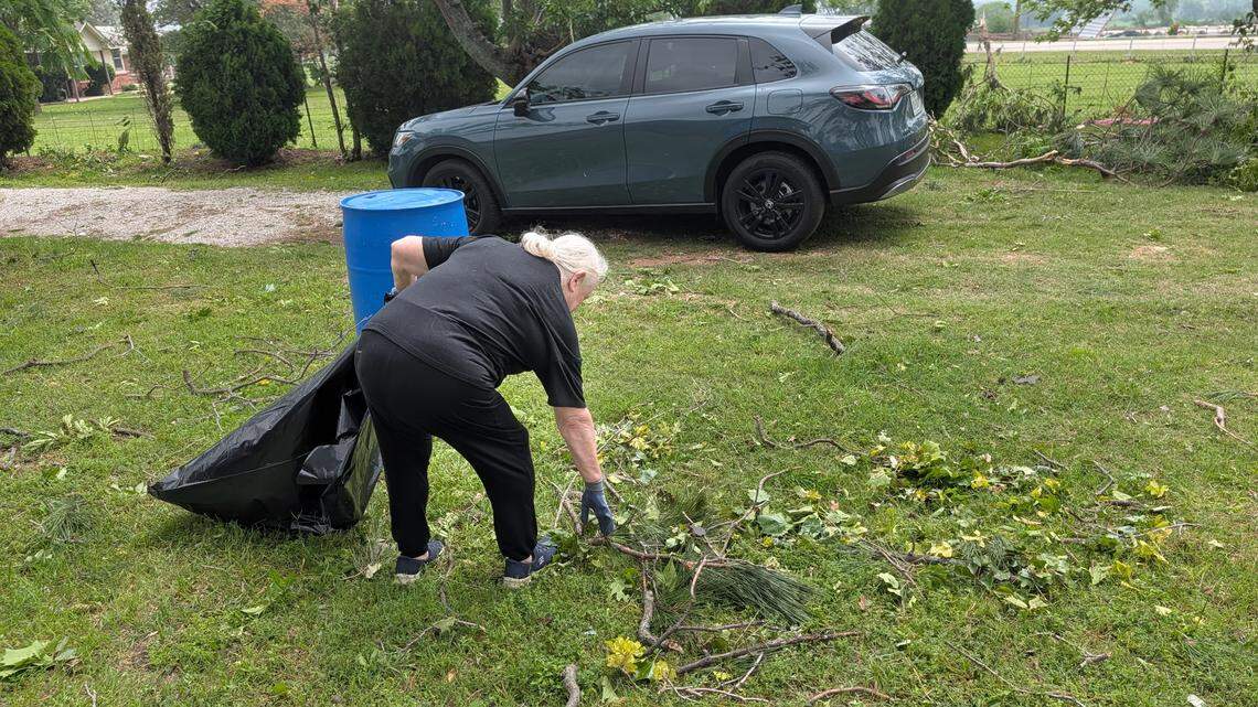 Lifelong Springtown, Texas, resident Nadine Taliaferro, 72, picks up storm debris in her yard on J E Woody Road on Sunday, April 26, 2026.