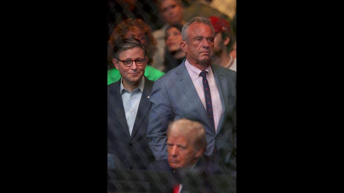 Nov 16, 2024; New York, NY, USA; Speaker of the house Mike Johnson (left) stands with Robert F. Kennedy Jr. (right) behind president-elect Donald Trump during UFC 309 at Madison Square Garden. Mandatory Credit: Brad Penner-Imagn Images