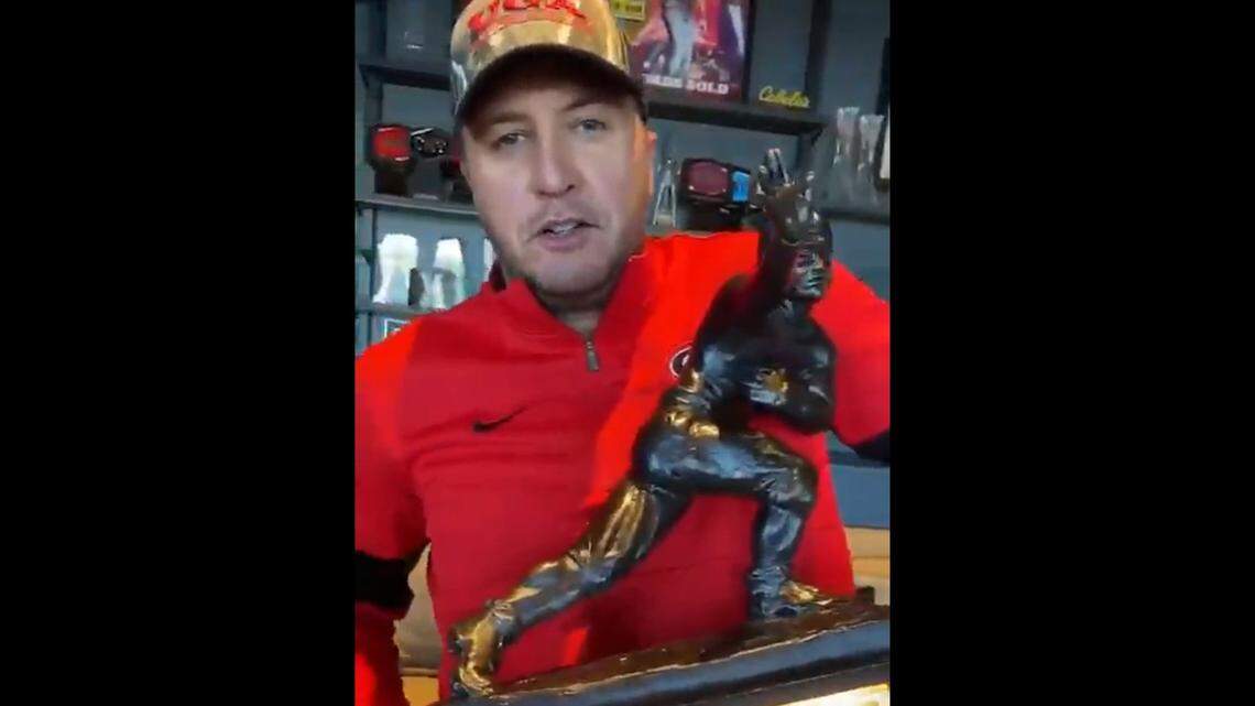 Luke Bryan is holding Tim Tebow’s Heisman “hostage” — but for a good purpose.