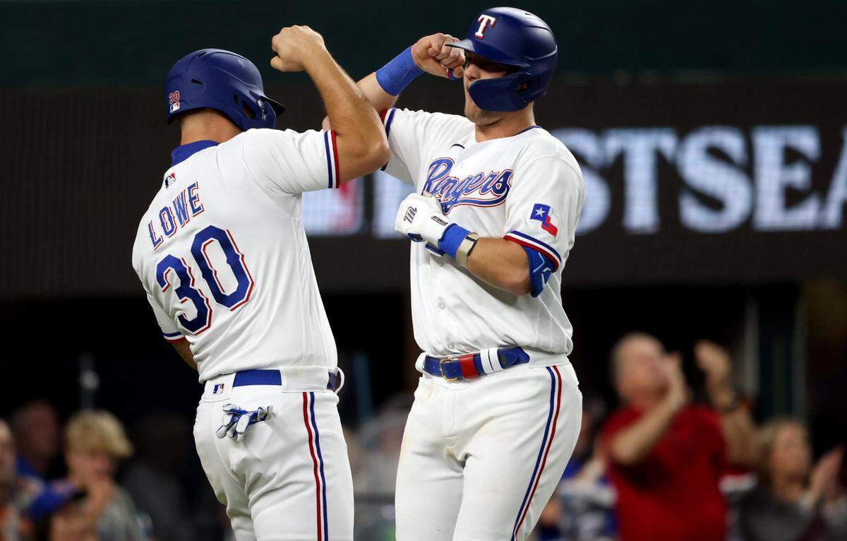 Texas Rangers third baseman Josh Jung celebrates with teammate Nathaniel Lowe after hitting a homer in the fifth inning of Game 3 of the ALCS at Globe Life Field in Arlington on Wednesday, October 18, 2023.