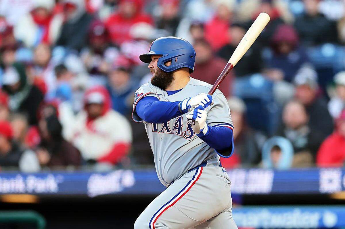 PHILADELPHIA, PENNSYLVANIA - MARCH 28: Jake Burger #21 of the Texas Rangers singles in the eighth inning during a game against the Philadelphia Phillies at Citizens Bank Park on March 28, 2026 in Philadelphia, Pennsylvania. The Rangers won 5-4 in 10 innings. (Photo by Hunter Martin/Getty Images)