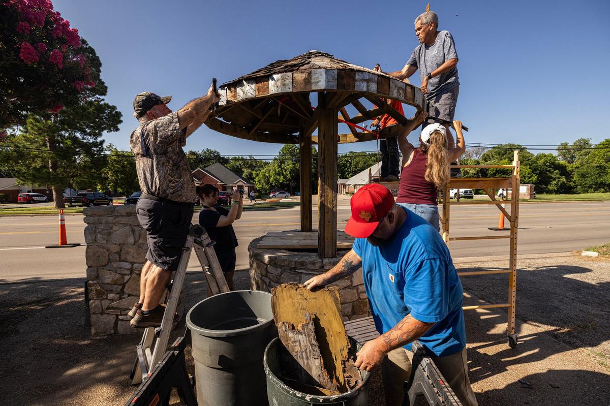 Hughes family friends begin to work on the Bedford Well during a restoration project in Bedford on Saturday. Hughes chose to repair a well that is significant in Bedford’s history as the city’s founder built it as a rest stop for travelers going from Grapevine to Fort Worth.