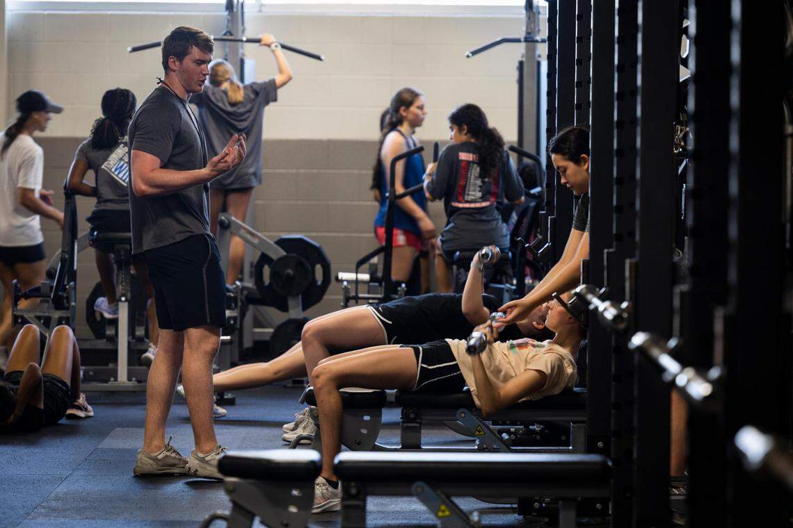 Owen Rogers, a strength and conditioning coordinator, works with students during summer camp at Arlington Martin.