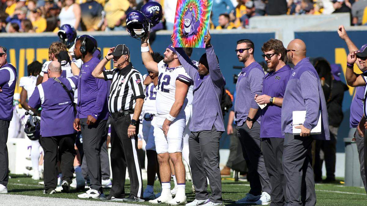 TCU players and staff celebrate during the first half of an NCAA college football game against West Virginia in Morgantown, W.Va., Saturday, Oct. 29, 2022. (AP Photo/Kathleen Batten)