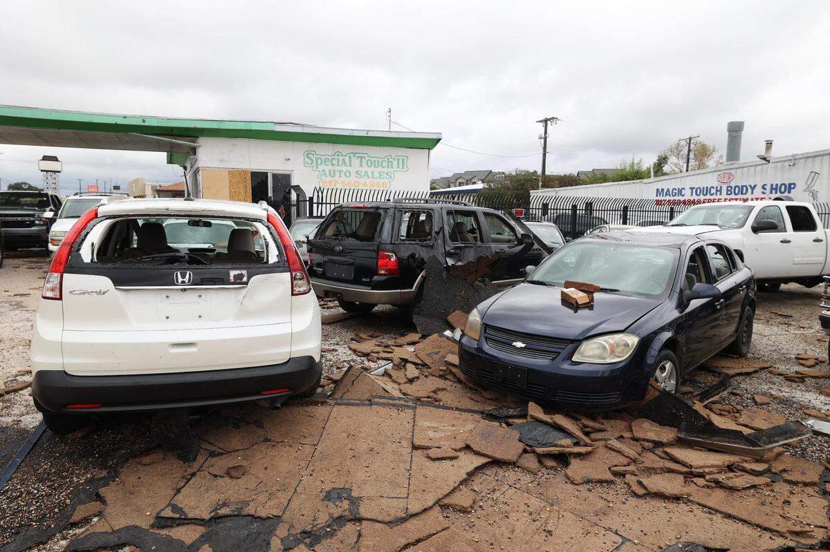 Numerous vehicles at Special Touch Auto Sales can be seen on Thursday, October 5, 2023, after severe thunderstorms swept through the area Wednesday evening in Fort Worth. A roof ripped off a nearby shopping center landed onto the car lot.