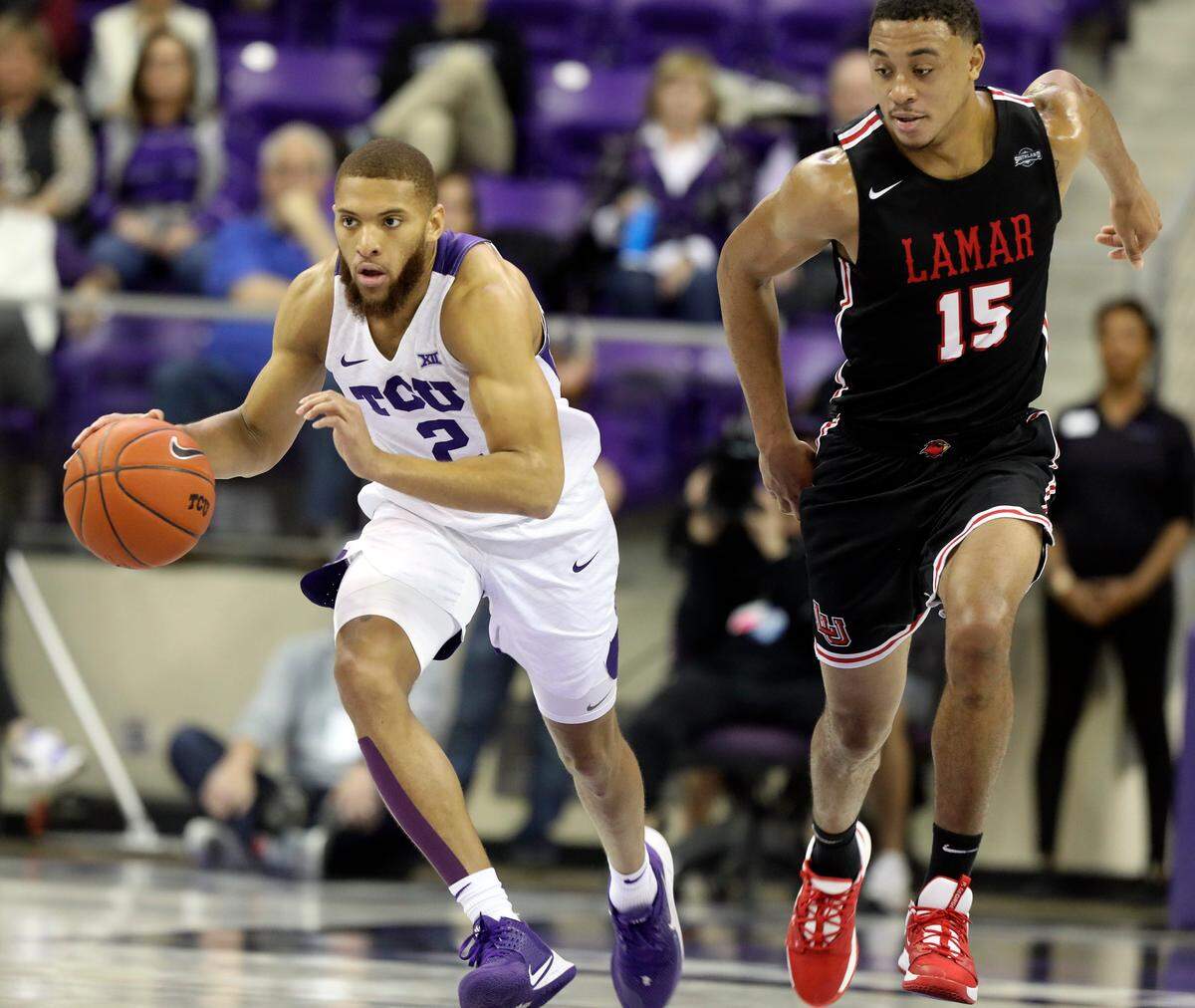 TCU guard Edric Dennis (2) brings the ball downcourt, chased by Lamar guard T.J. Atwood (15), in the first half of an NCAA basketball game at Schollmaier Arena in Fort Worth, Texas, Saturday, Dec. 14, 2019.