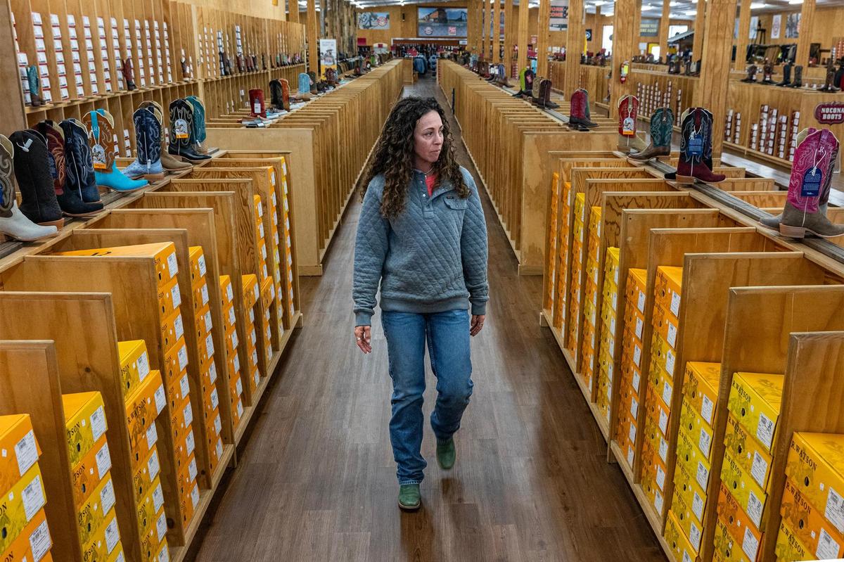 General manager Brandi Moan surveys the aisles at Justin Discount Boots in Justin on Jan. 23. Moan has worked in Justin for 16 years and has seen the community grow with rapid pace.