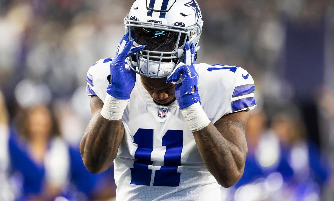Dallas Cowboys linebacker Micah Parsons puts on his helmet before the start of the 2022 season opener against the Tampa Bay Buccaneers at AT&T Stadium in Arlington.