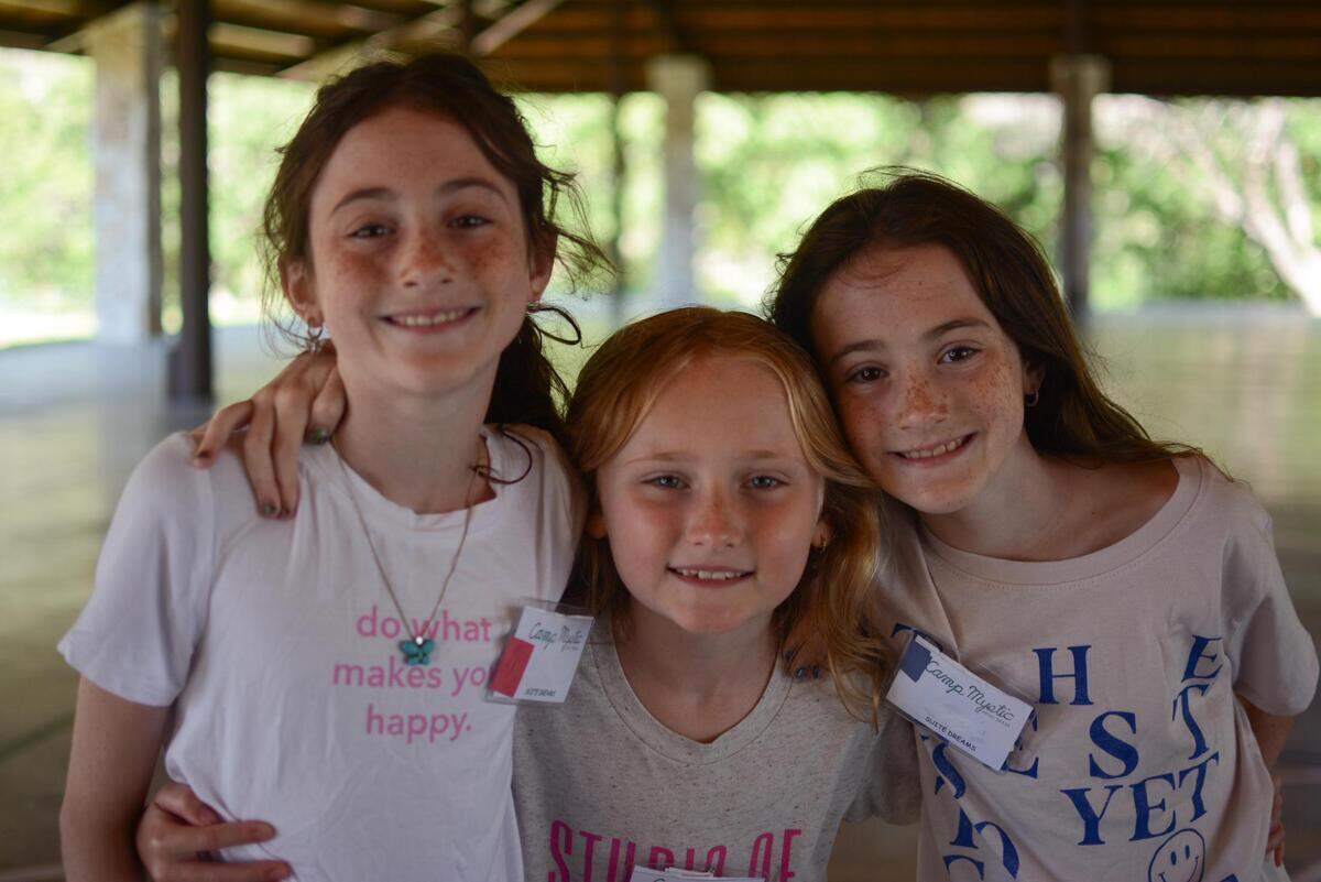 Coco Grieshaber, center, is pictured at Camp Mystic with twin siblings Audrey and Elizabeth Hernandez. The 8-year-old Fort Worth trio attended the camp together in June 2025 before flooding devastated the area on Fourth of July weekend. They’ve been making and selling bracelets with Coco’s older sister Max, another Camp Mystic alumna, to raise funds for a Camp Mystic staffer who was impacted by the flooding.