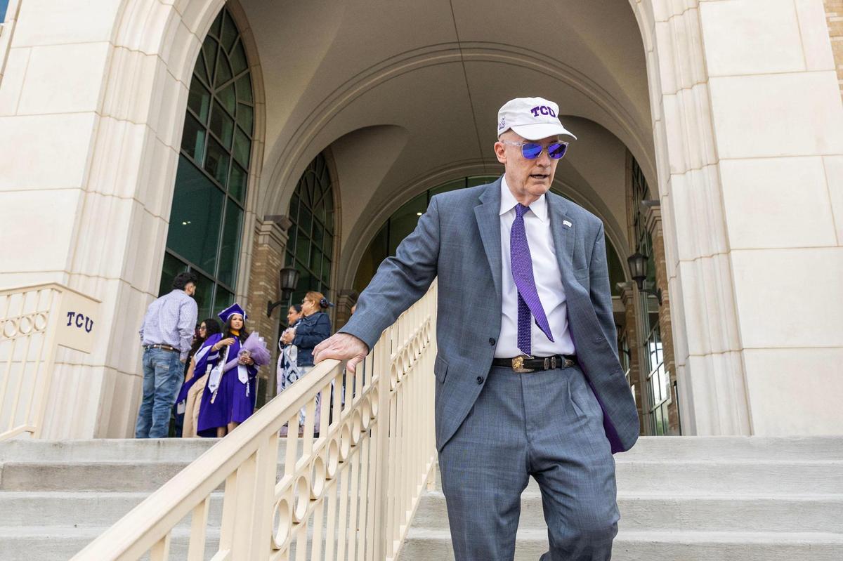 TCU Chancellor Victor J. Boschini Jr. walks down the stairs outside Brown-Lupton University Union on Friday, May 9, a busy day of attending graduation events.