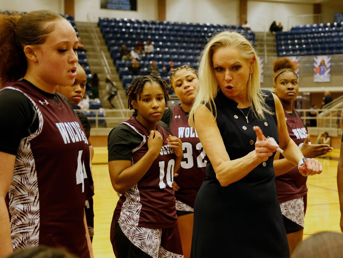 Timberview head coach Kit Martin talks to the team during a time out in the first half of a high school basketball game at Summit High School in Mansfield, Texas, Tuesday, Jan, 30, 2024.