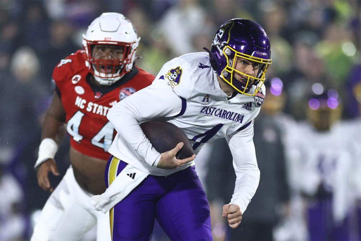 ANNAPOLIS, MARYLAND - DECEMBER 28: Katin Houser #4 of the East Carolina Pirates rushes the ball during the first quarter against the North Carolina State Wolfpack the Go Bowling Military Bowl at Navy-Marine Corps Memorial Stadium on December 28, 2024 in Annapolis, Maryland. (Photo by Timothy Nwachukwu/Getty Images)