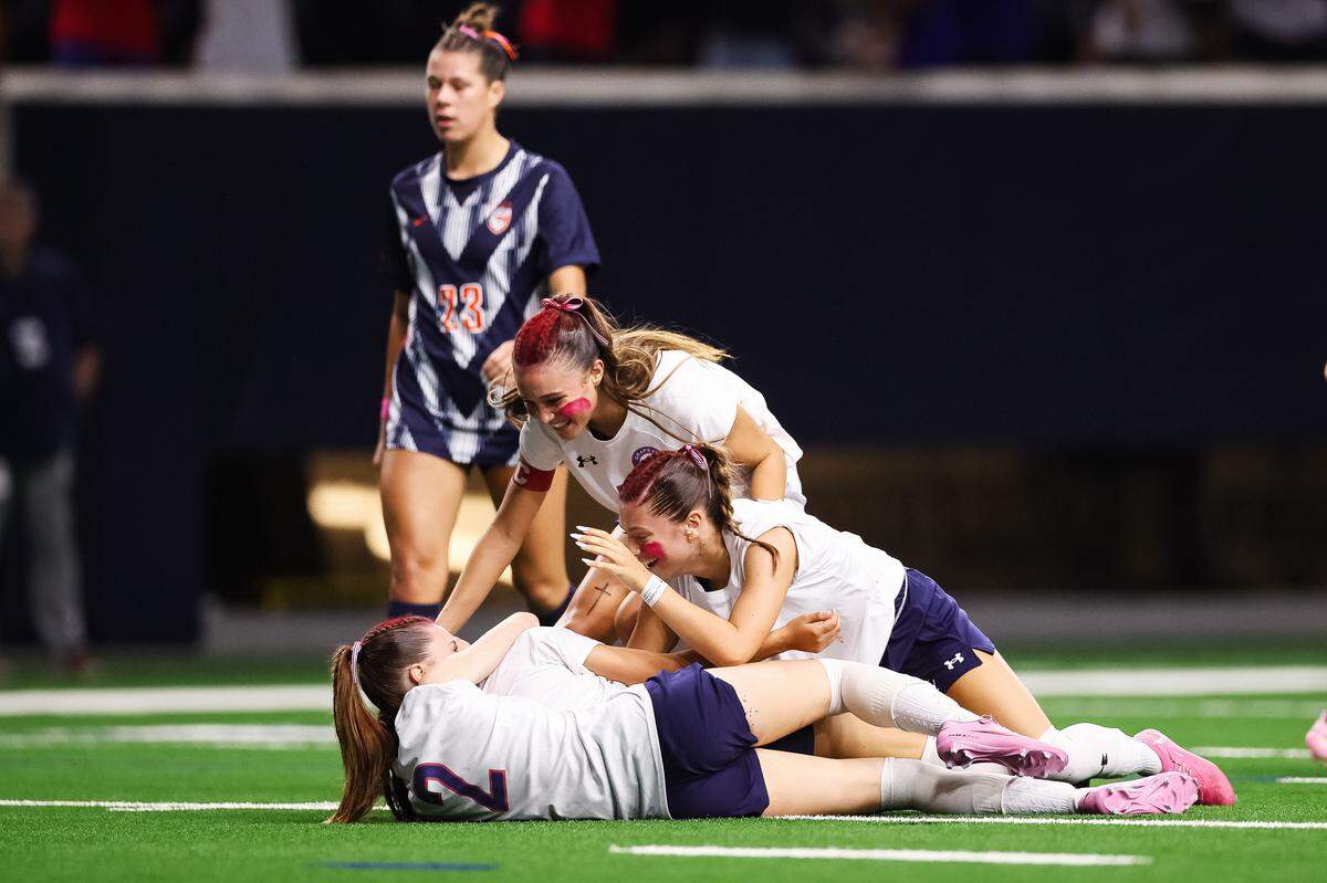 Grapevine players piled onto Grapevine forward Paola Granados (28) after she scored a goal against Frisco Wakeland in a Class 5A Division II UIL girls soccer state semifinal at the Ford Center on April 3, 2026 in Frisco, Texas.