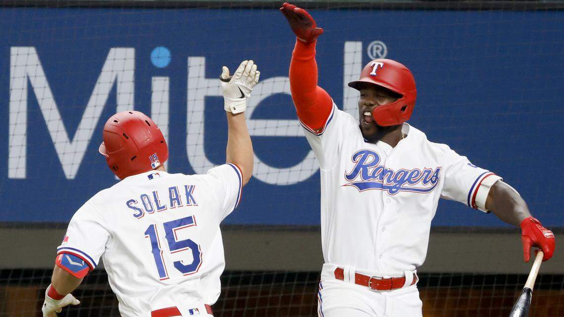 Texas Rangers second baseman Nick Solak, left, celebrates his seventh inning home run Tuesday night with teammate Adolis Garcia. Solak hit two on the night and is tied for the American League lead with seven on the season.