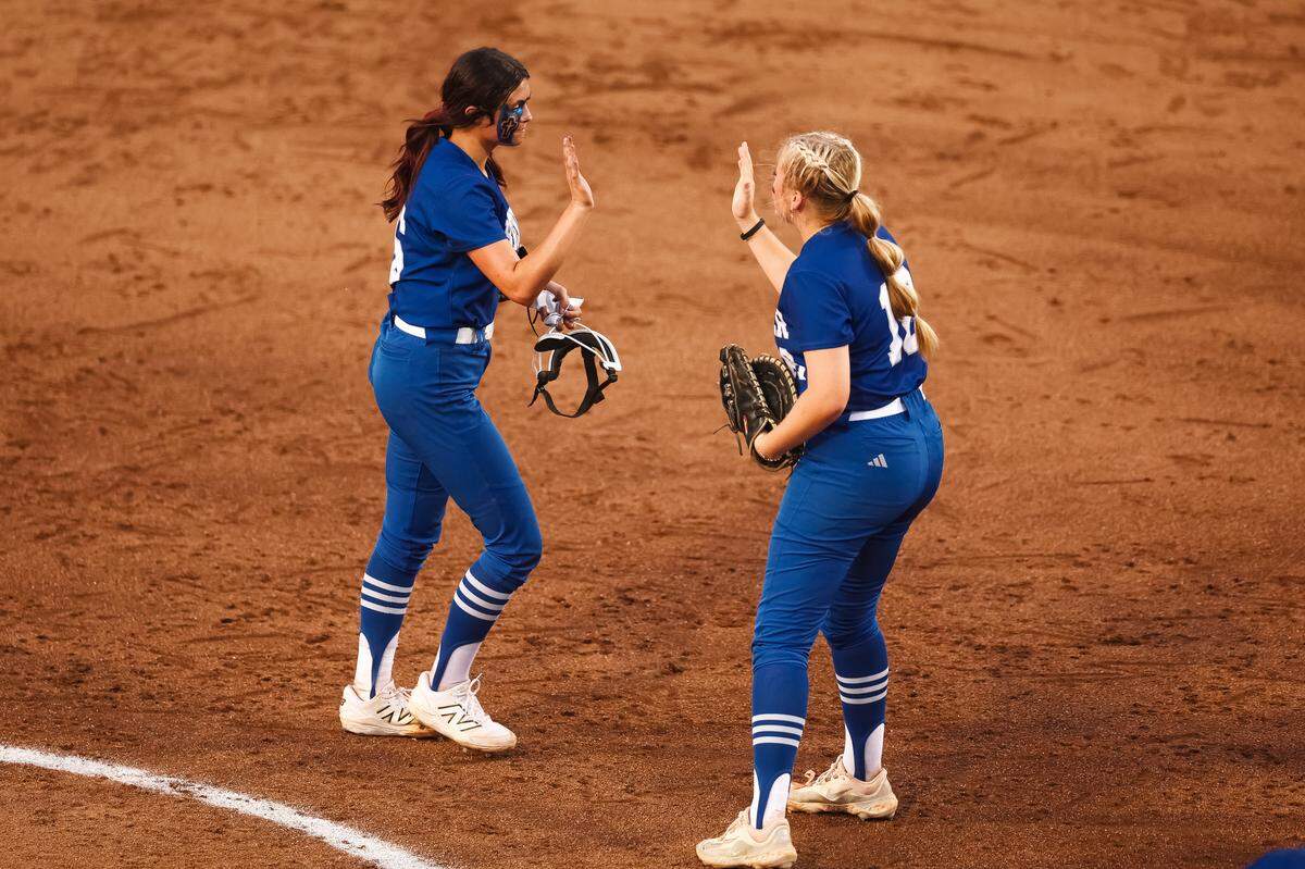 White Settlement Brewer pitcher Cozy Tyson (16) high fives first baseman Kamren Pride (18) after a strikeout to end an inning against Montgomery Lake Creek in the UIL Class 5A Division II state softball championship game at Red & Charline McCombs field in Austin, Texas, on Friday, May 29, 2026.