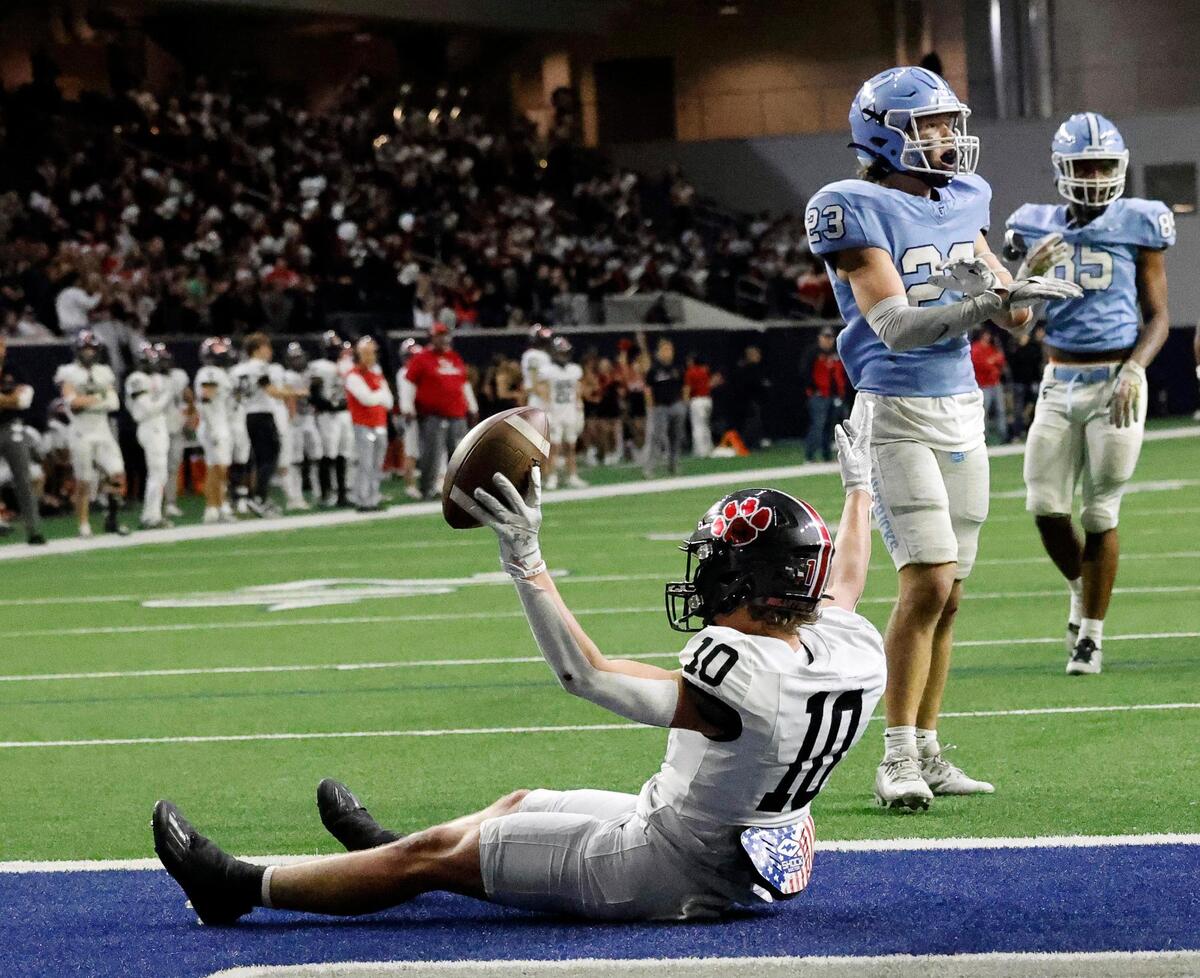 Colleyville Heritage wide receiver Kai Pruitt (10) displays his touchdown catch during the second half of a UIL Conference 5A Division 2 quarterfinal football playoff game at The Ford Center in Frisco, Texas, Friday, Dec. 01, 2023.