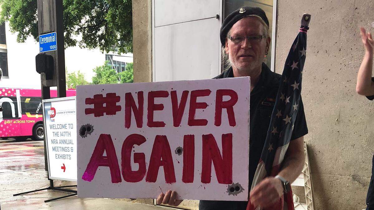 Military veteran Dave Lyles stands outside the NRA convention in Dallas on May 4, 2018, to protest regular citizens owning AR-15s.
