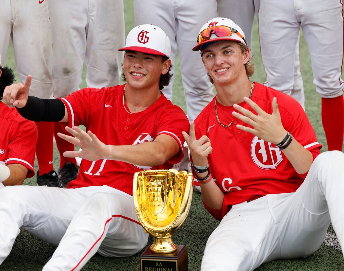 Grapevine third game pitcher JoJo Kubo and second game pitcher Dasan Hill pose with the 5A Regional trophy after a UIL Conference 5A Regional final baseball game at Nathan F. Sanford Field at L.D. Bell in Hurst, Texas, Saturday June 01, 2024.