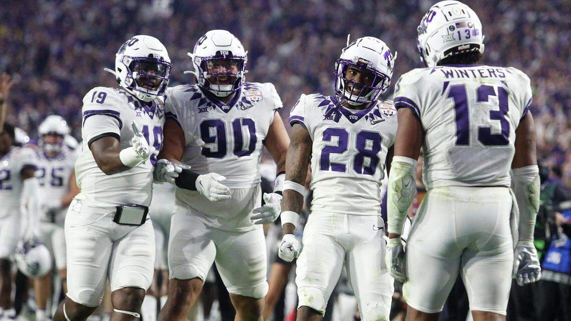 TCU linebacker Dee Winters, right, celebrates with teammates after returning an interception in for a touchdown at the Vrbo Fiesta Bowl at State Farm Stadium in Glendale, Ariz., on Saturday.