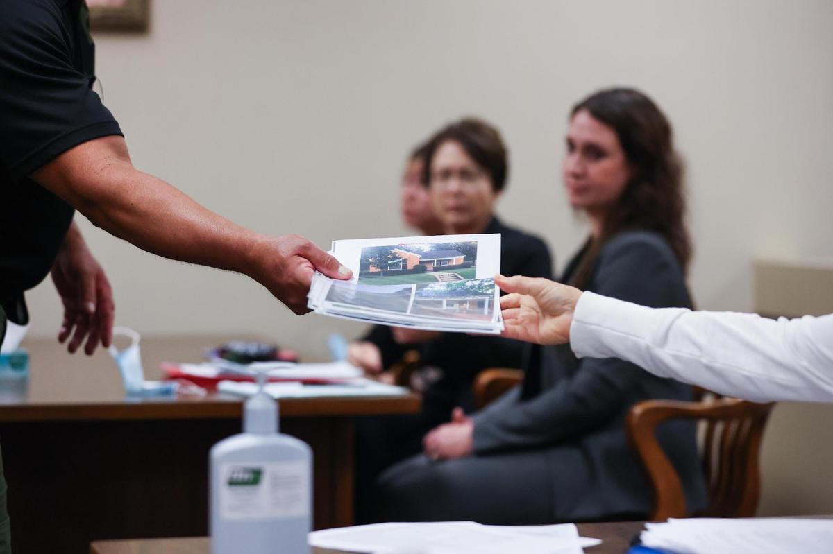 When tenants appear for eviction cases, judges can conduct full hearings, including hearing testimony and receiving evidence. Property owner Cathi Chambers hands photo evidence to Deputy Constable Ruben Hernandez during an eviction hearing in downtown Fort Worth.