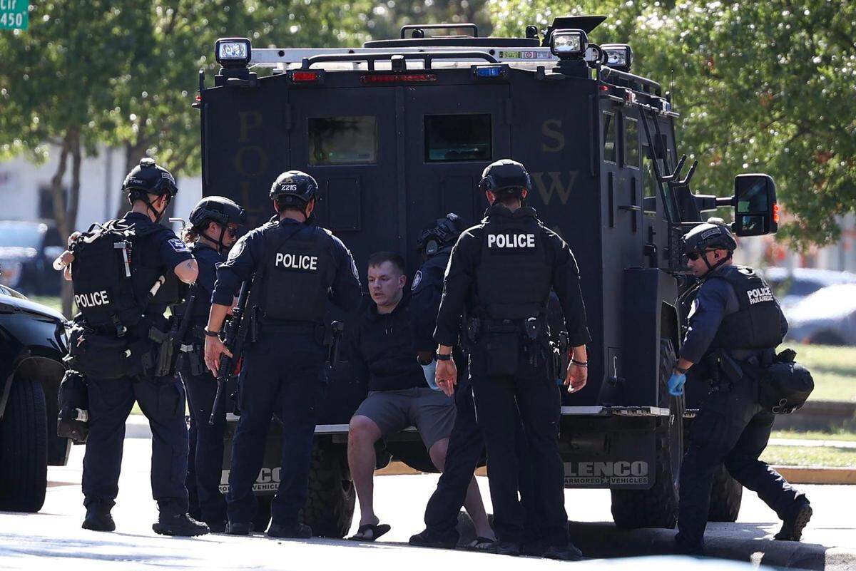 Members of the Fort Worth Police Department detain a suspect accused of firing a gun in the air outside businesses on Bluebonnet Circle on Thursday, October 12, 2023, in Fort Worth.