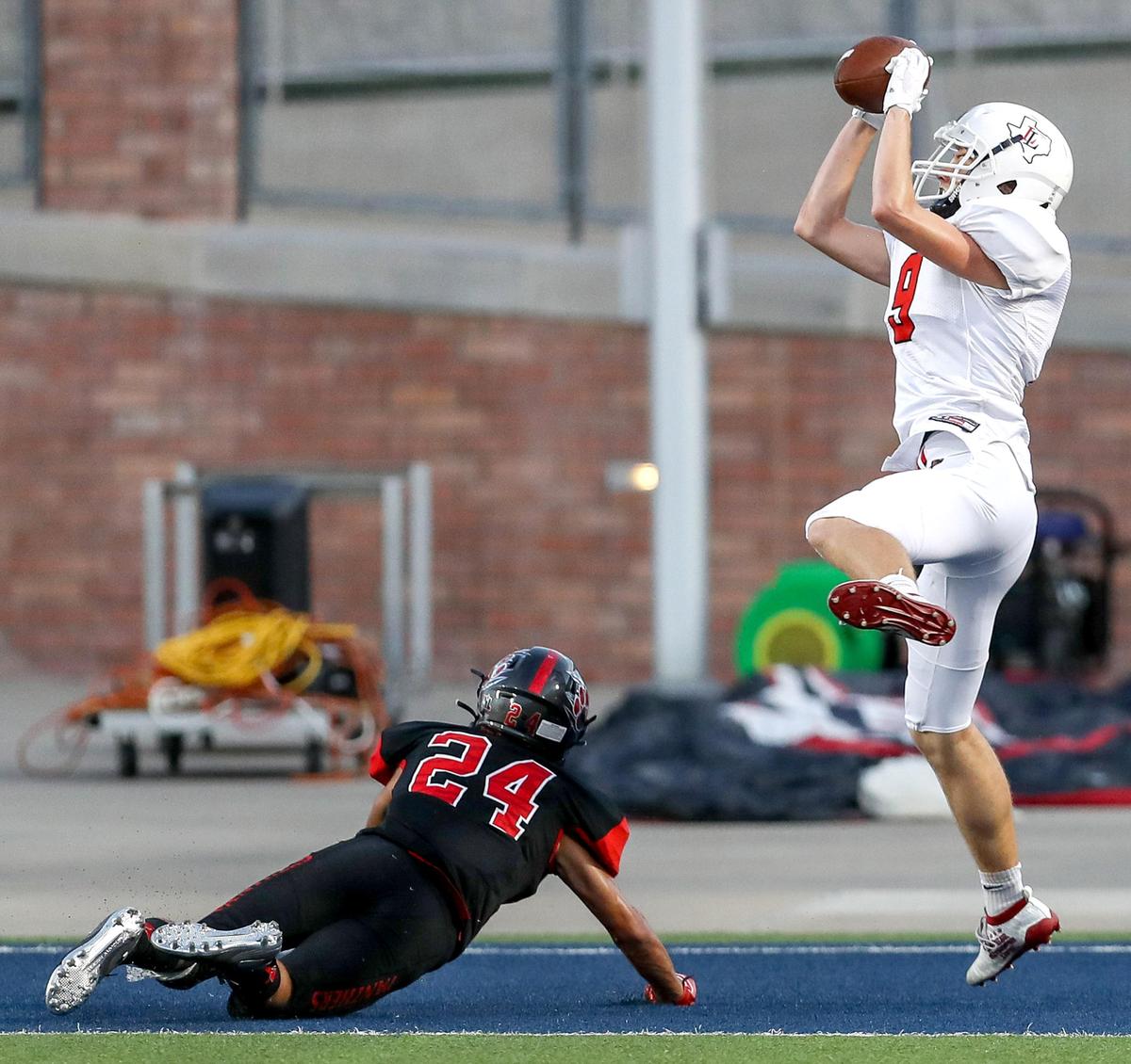 Lovejoy wide receiver Reid Westervelt (9) goes up for a 21 yard touchdown reception against Colleyville Heritage cornerback Michael Neves (24) during the first half, Saturday night, August 31, 2019 played at Eagles Stadium in Allen, TX.