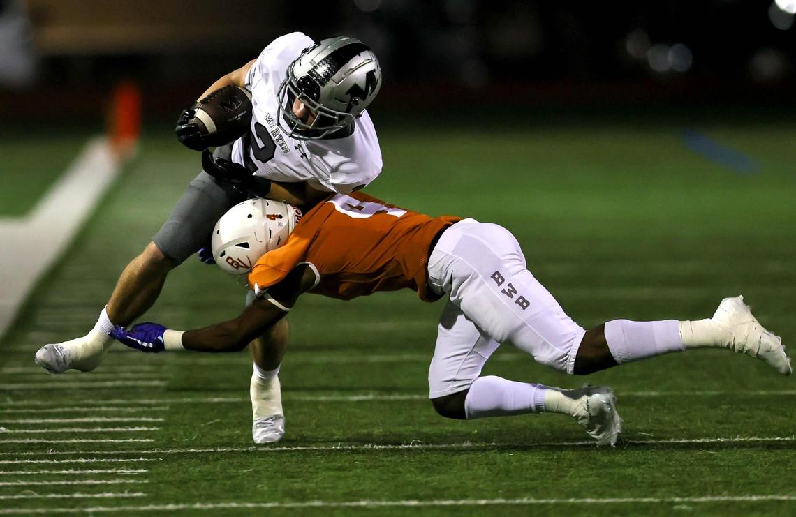 Arlington Martin receiver Cal Robinson (2) comes up with a reception and is stopped by Arlington Bowie defensive back Trint Scott (4) during the first half of a high school football game, Friday night, November 6, 2020 played at Wilemon Field in Arlington, Tx. (Steve Nurenberg Special to the Star-Telegram)