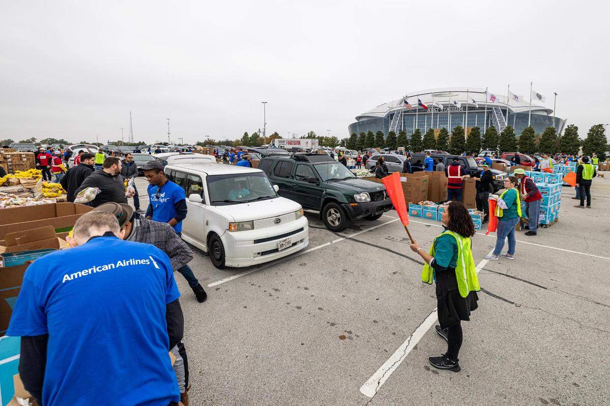 Thousands of cars line up for the 4th annual Thanksgiving Mobile food distribution at AT&T Stadium in Arlington on Friday, November 17, 2023.