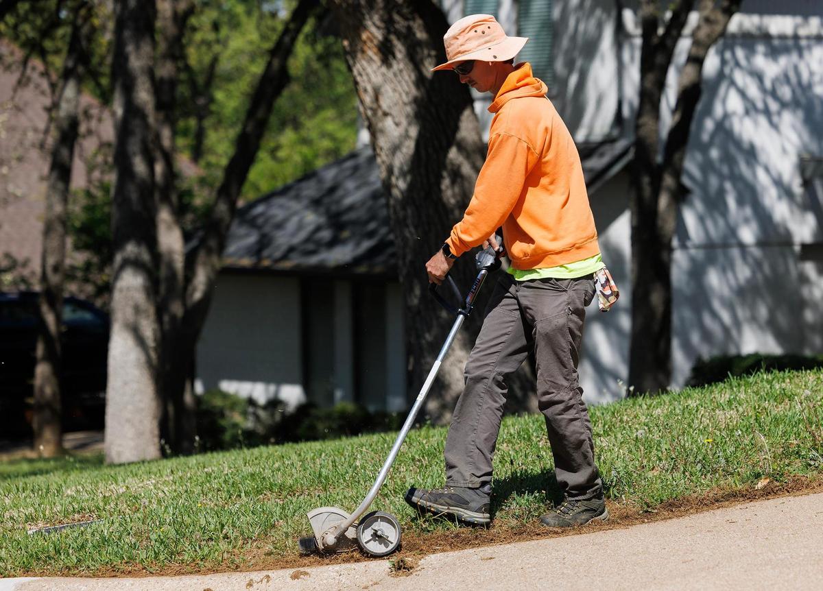 Hunter Mixson works on his job as a landscaper on Tuesday, April 8, 2025, in Keller.