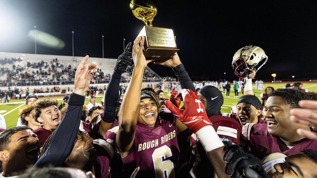 Saginaw wide receiver Isaiah Verdun (6) holds up the championship trophy after defeating Azle 41-39 in the Class 5A Division I playoffs at Rough Rider Stadium in Saginaw on Friday, Nov. 15, 2024. Verdun scored the game-winning touchdown to seal Saginaw High School’s first playoff win in school history.