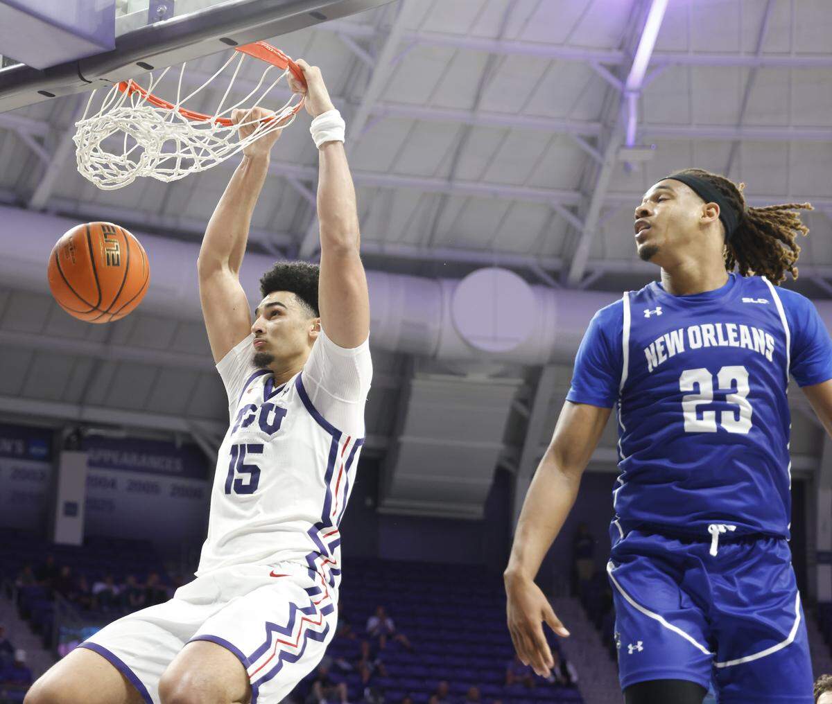 TCU forward David Punch (15) makes a statement in front of New Orleans forward MJ Thomas (23) during the second half of a NCAA basketball game between New Orleans University and TCU at Schollmaier Arena in Fort Worth, Texas, Monday Nov. 03, 2025. The Horned Frogs dropped their home opener 78-74 to the Privateers.