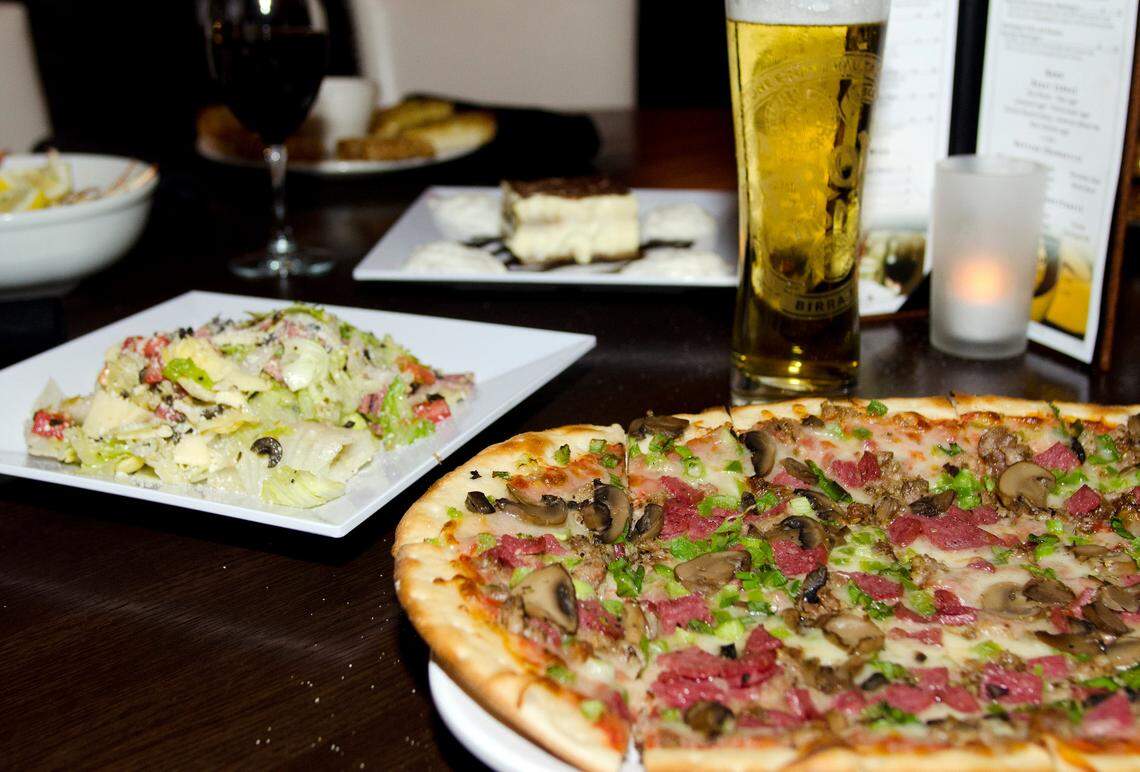 An “all the way” pizza with a chopped salad at Campisi’s.