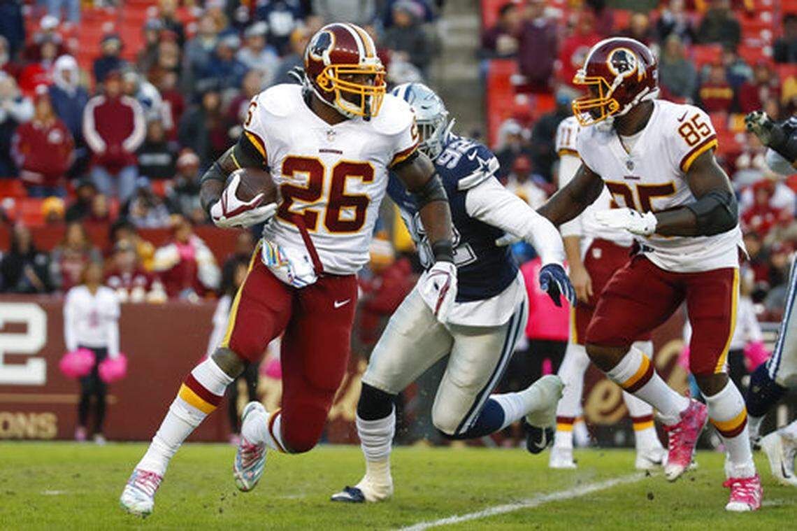 Washington Redskins running back Adrian Peterson (26) carries the ball during the second half of an NFL football game against the Dallas Cowboys, Sunday, Oct. 21, 2018, in Landover, Md. (AP Photo/Alex Brandon)