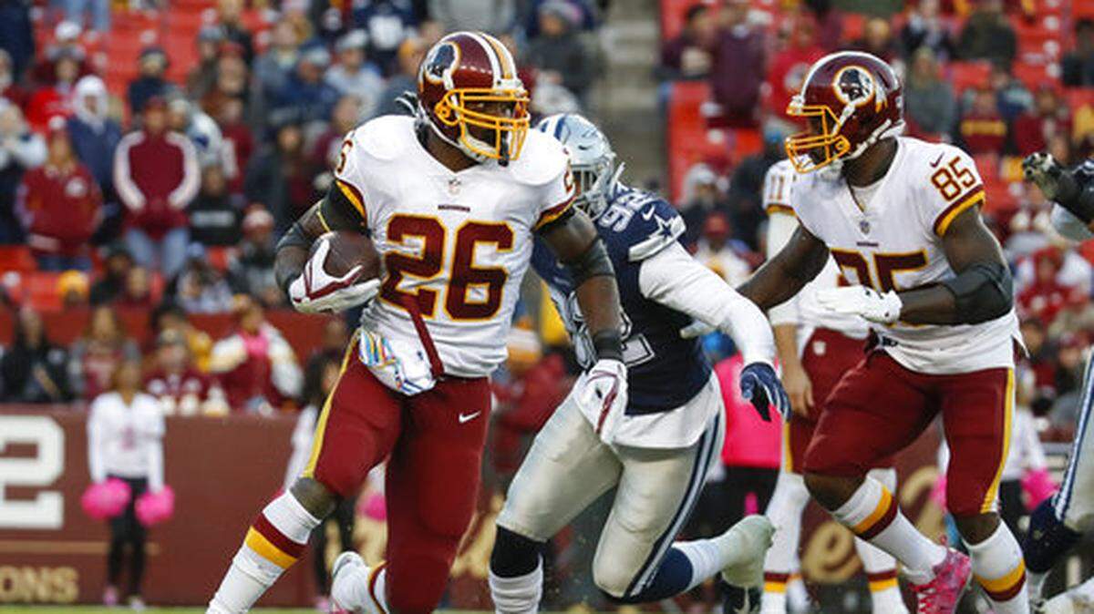Washington Redskins running back Adrian Peterson (26) carries the ball during the second half of an NFL football game against the Dallas Cowboys, Sunday, Oct. 21, 2018, in Landover, Md. (AP Photo/Alex Brandon)