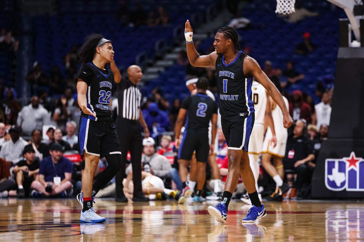 North Crowley forward Alex Barther II (1) high-fives teammate Isaak Hayes after a play in the Class 6A Division I state championship game against San Antonio Brennan on Saturday at the Alamodome in San Antonio.