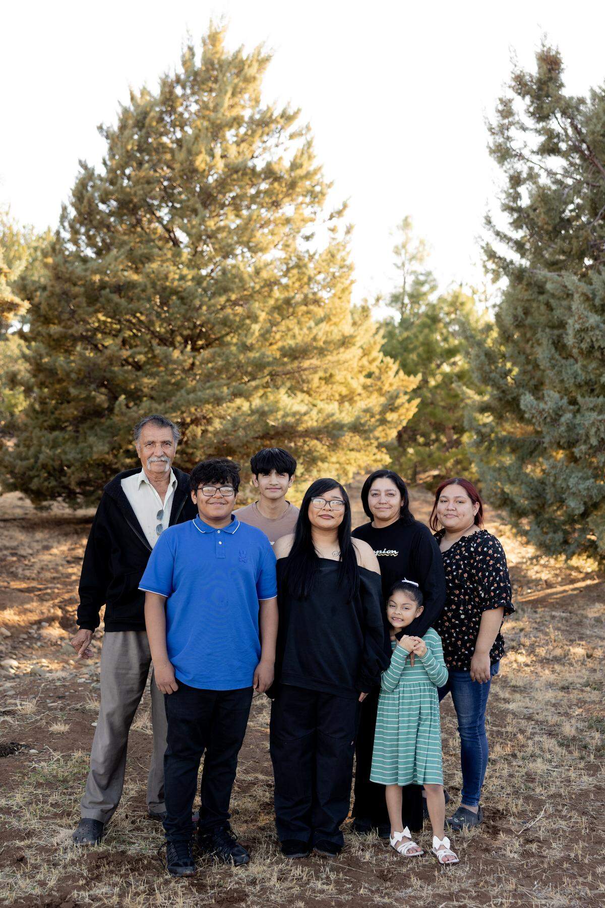 From left, Francisco Perez; Francisco Perez IV, 12; Daniel Perez, 14; Gabriella Perez; Evangelina Perez; Cecilia Perez, 6; and Angelica Perez pose for a portrait down the street from their home in Prescott Valley, Arizona, on Sunday, March 9, 2025.