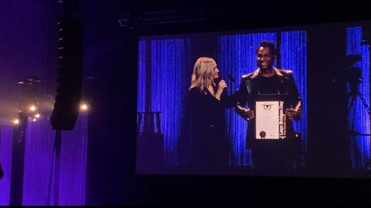 Fort Worth Mayor Mattie Parker presents singer Leon Bridges with a proclamation Friday at Dickies Arena that November 15 will henceforth be known as Leon Bridges Day, in honor of the singer’s contributions to the city.