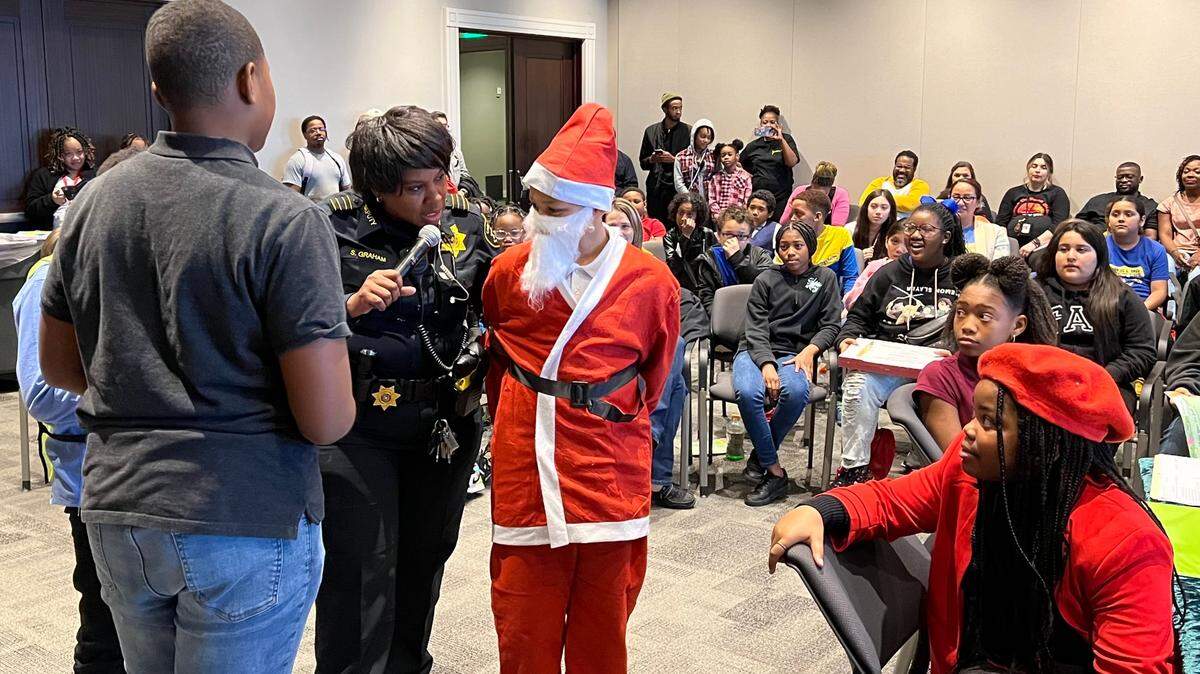 Braden Barrow, a fifth-grader from Oakmont Elementary, is arrested while playing Santa Claus in a play called “Santa Claus Goes to Jail” on Friday at the Tarrant County Family Law Center in downtown Fort Worth.