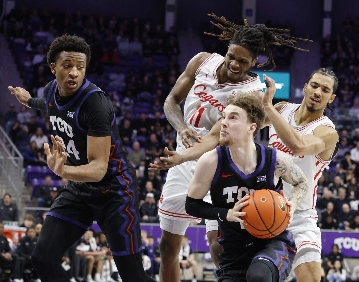 TCU guard Brock Harding (2) gets into the key in front of Houston forward Joseph Tugler (11) and guard Milos Uzan (7) during the first half of a NCAA basketball game between the University of Houston and TCU at Schollmaier Arena in Fort Worth, Texas, Wednesday Jan. 26, 2026