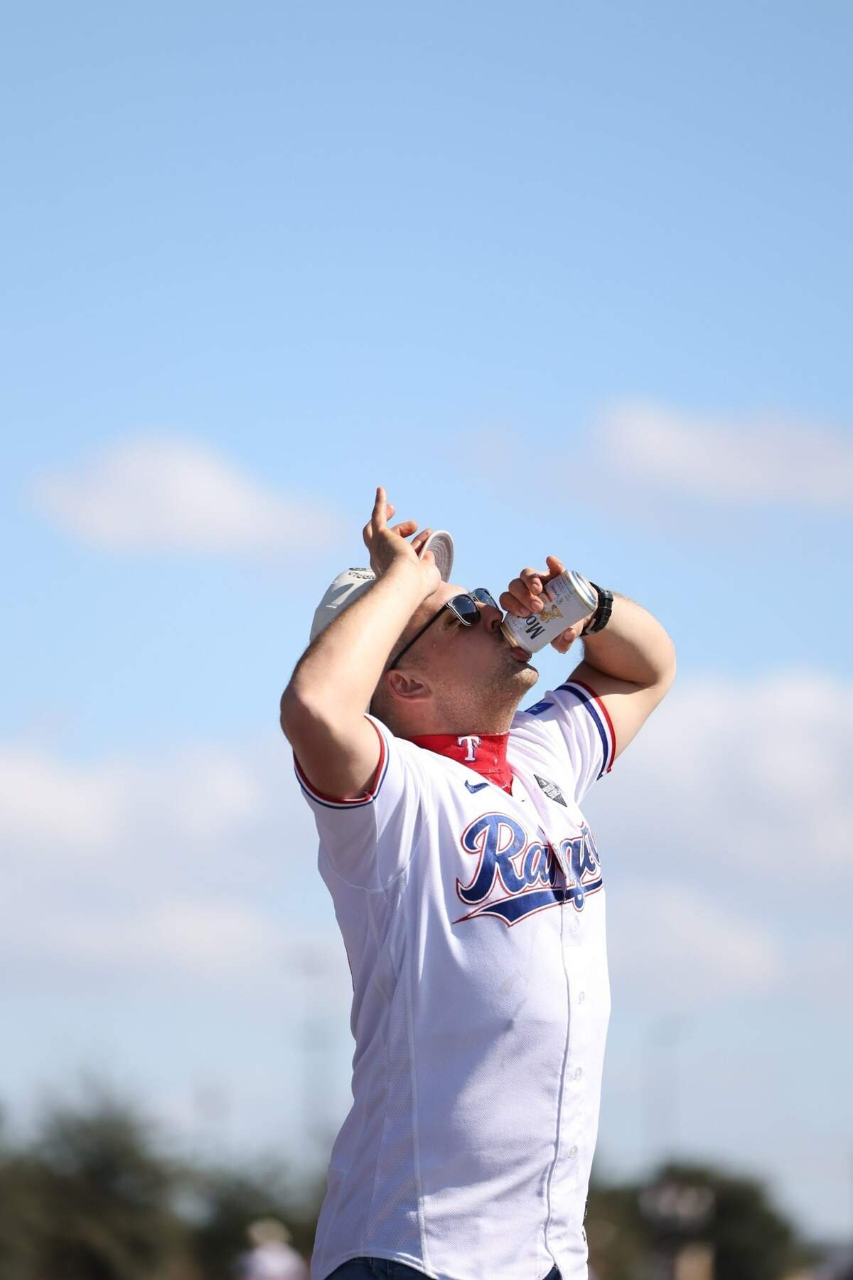 Texas Rangers first baseman Nathaniel Lowe chugs a beer during the World Series parade in Arlington on Friday, Nov. 2, 2023.