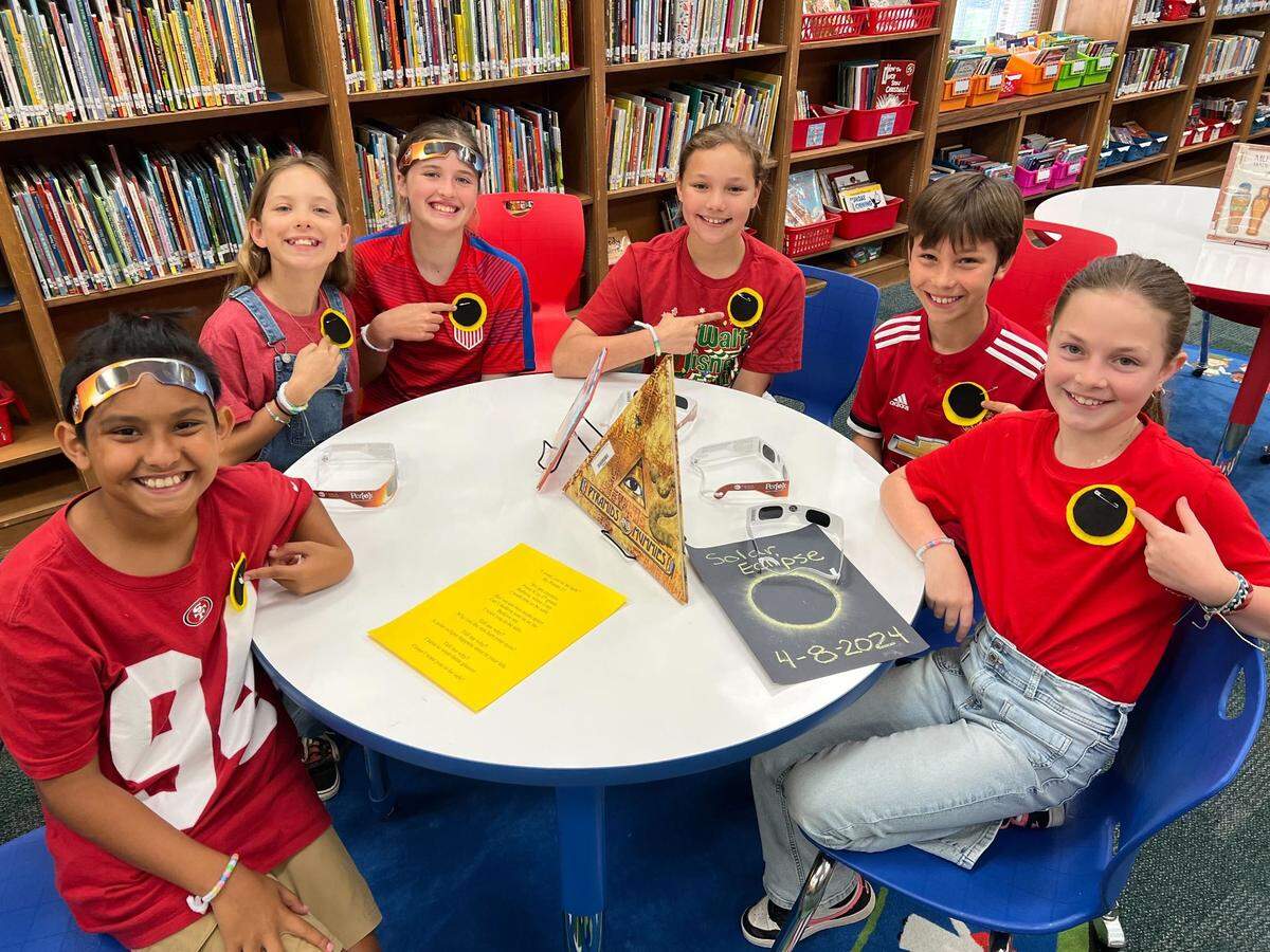 Fifth-graders at Alice Carlson Applied Learning Center pose with their handmade solar eclipse pins before heading outside to watch the celestial event. Left to right: Isiah Silvestre, Bellamy Henderson, Evangeline DeSonier, Emma Groat, George Meier and Lily Huckaby.