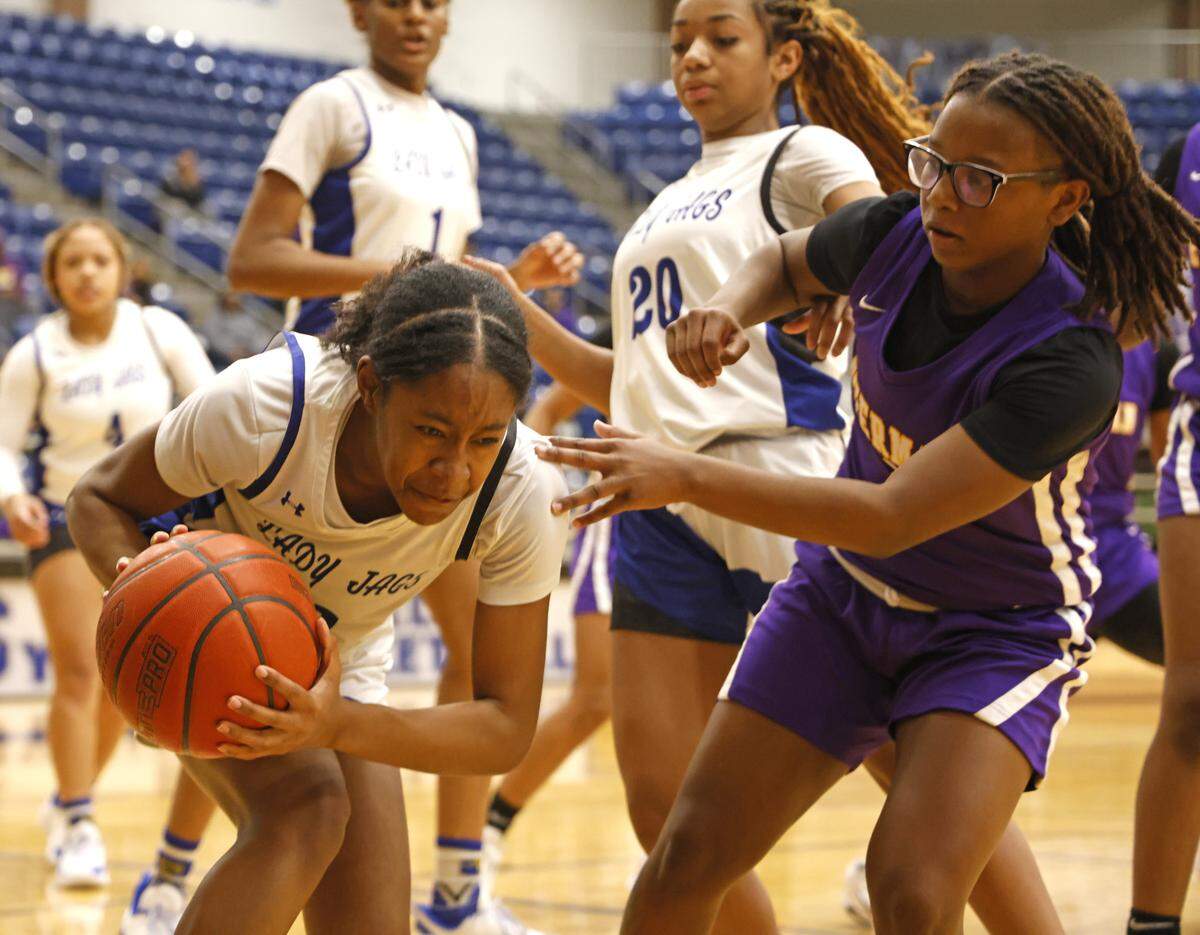 Mansfield Summit shooting guard Aryn Williamson (2) grabs a rebound in front of Everman shooting guard Makhiya Dangerfield (1) during the first half of a UIL girls basketball game between Everman and Mansfield Summit at Summit High School in Mansfield, Texas, Thursday Jan. 22, 2026