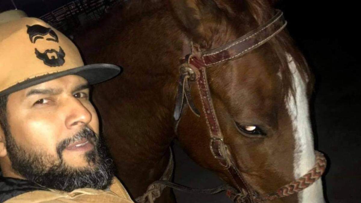 Arnulfo Omar Martinez poses for a photo with his horse, Hammer. The 43-year-old was shot and killed on Aug. 6 at the stables where he kept the horse, with his 13-year-old son nearby, according to his wife and sister-in-law.