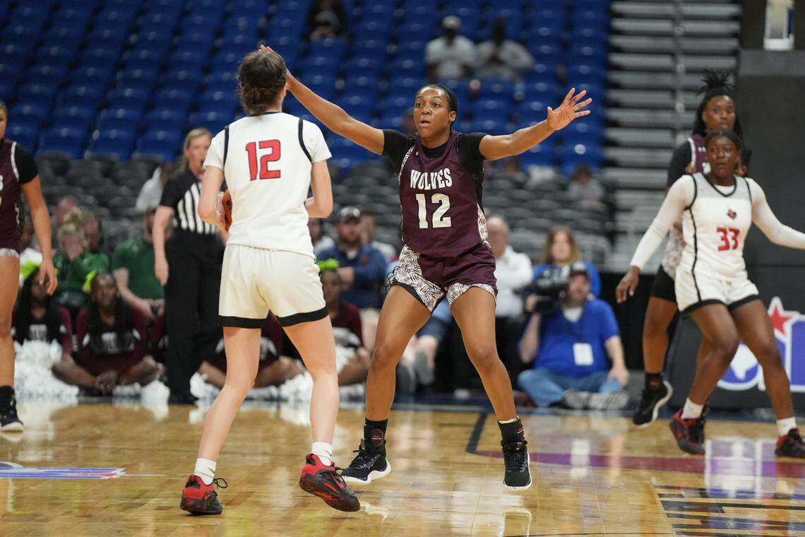 Mansfield Timberview’s Chrishawn Coleman (12 in maroon) guards Frisco Liberty’s Kathryn Murphy (12 in white) in the Class 5A state championship game on Saturday, March 2, 2024 at the Alamodome in San Antonio, Texas. Liberty defeated Timberview 60-51.