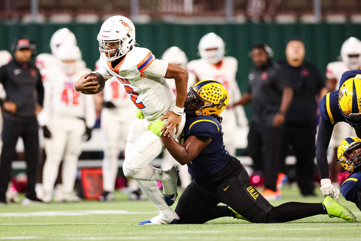 Arlington Bowie quarterback Jayden Bibbs (2) is tackled while running with the football in a district match up against Arlington Lamar at Choctaw Stadium in Arlington, Texas on October 30, 2025.