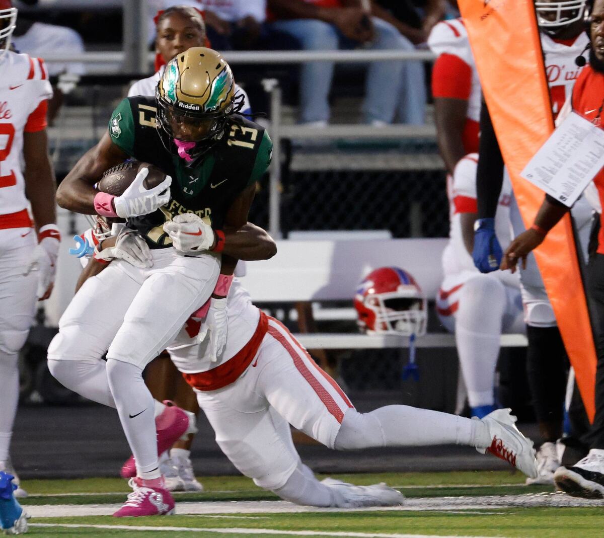 DeSoto wide receiver Daylon Singleton (13) grabs a pass along Duncanville’s sidelines during a District 11-6A football game at Eagle Stadium in DeSoto, Texas, Friday, Oct. 11, 2024.